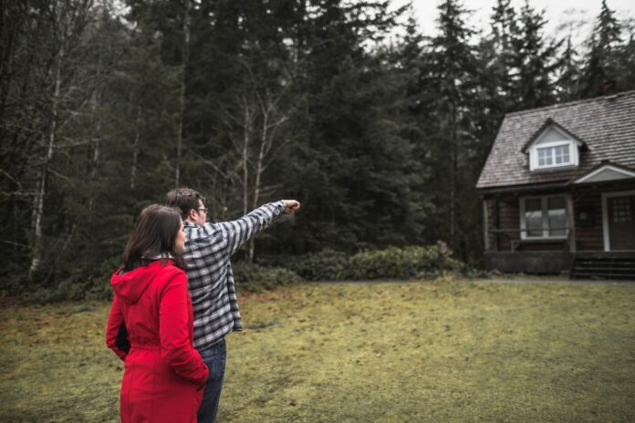 couple-pointing-cabin_23-2147833126