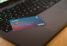 De l’or dans votre carte bancaire : ne la jetez plus ! Carte bancaire dégradé bleu et rose avec sa puce dorée (or) posée sur un clavier d'ordinateur portable ouvert.